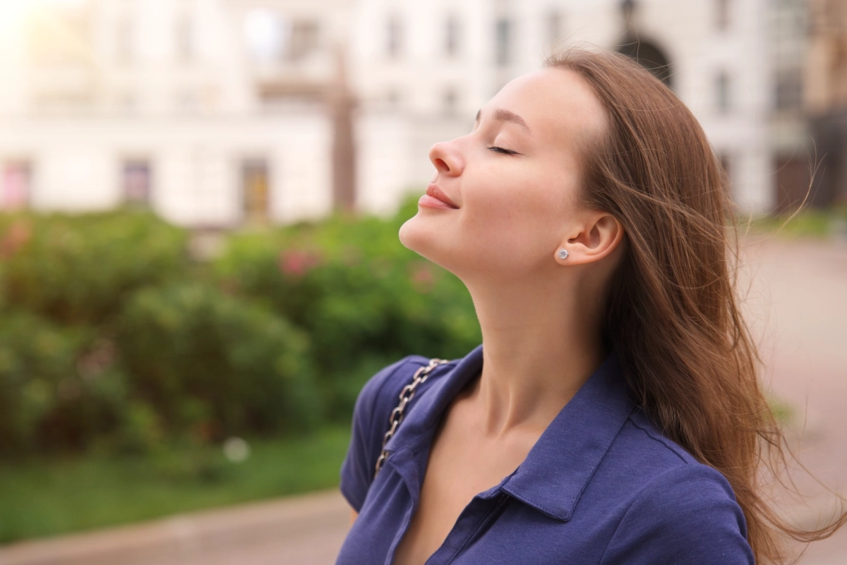Woman breathing in clean air